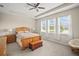 Bedroom featuring a light wood bed frame, a chest, carpeted floors, and lots of natural light from bright windows at 226 Tapa Parish Run, Bradenton, FL 34212