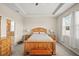Well-lit bedroom featuring a light wood bed frame, carpeted floors, and an ensuite bathroom at 226 Tapa Parish Run, Bradenton, FL 34212