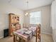 Cozy dining area with a wooden table set, hutch, and ample natural light from a nearby window at 226 Tapa Parish Run, Bradenton, FL 34212