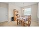 Charming dining area featuring a wooden table set, a classic hutch, and a bright window at 226 Tapa Parish Run, Bradenton, FL 34212