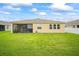 Back exterior of the home with a screened-in patio and spacious backyard at 226 Tapa Parish Run, Bradenton, FL 34212