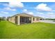 Rear exterior view of home featuring a screened-in patio and large backyard space at 226 Tapa Parish Run, Bradenton, FL 34212