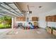 Clean garage with epoxy floor, storage cabinets, and organized lawn care equipment at 226 Tapa Parish Run, Bradenton, FL 34212