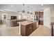 Open-concept kitchen with island and stainless appliances flowing into the living room at 226 Tapa Parish Run, Bradenton, FL 34212