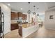 Modern kitchen featuring a granite island, stainless steel appliances, and an adjacent dining area at 226 Tapa Parish Run, Bradenton, FL 34212