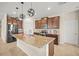 Modern kitchen featuring granite countertops, stainless steel appliances, and a center island with sink at 226 Tapa Parish Run, Bradenton, FL 34212