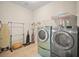 Functional laundry room equipped with a washer, dryer, and storage solutions at 226 Tapa Parish Run, Bradenton, FL 34212