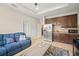 Cozy living area seamlessly blends into a modern kitchen with stainless steel appliances and a snack and beverage area at 226 Tapa Parish Run, Bradenton, FL 34212