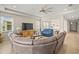 Inviting open-concept living room with neutral tones, a sectional sofa, and tile flooring at 226 Tapa Parish Run, Bradenton, FL 34212