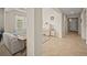 Open-concept living space with tile flooring, featuring a piano, a couch, and an airy hallway at 226 Tapa Parish Run, Bradenton, FL 34212