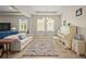 Bright living room featuring large windows, tile flooring, a piano and neutral-colored walls at 226 Tapa Parish Run, Bradenton, FL 34212