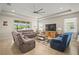 Spacious living room with plush seating, tile floors, a ceiling fan, and natural light at 226 Tapa Parish Run, Bradenton, FL 34212