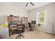 Bright home office with dual workstations and natural light streaming through the window at 226 Tapa Parish Run, Bradenton, FL 34212