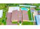 Aerial view of backyard pool, lounging area, and manicured lawn at 2315 Riverwood Pines Dr, Sarasota, FL 34231