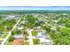 Scenic aerial shot highlighting a home with a private pool nestled in a vibrant, tree-filled residential area near the water at 2315 Riverwood Pines Dr, Sarasota, FL 34231