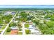 Overhead view featuring a home with a pool in a community, surrounded by lush greenery and other residential properties at 2315 Riverwood Pines Dr, Sarasota, FL 34231