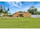 Backyard view of the home's exterior showcasing the expansive grassy yard at 2315 Riverwood Pines Dr, Sarasota, FL 34231