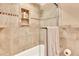 Bathroom showing shower with glass door and tiled walls, with shelving niche at 2315 Riverwood Pines Dr, Sarasota, FL 34231