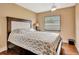 Bedroom with wooden floors, large bed, ceiling fan and window at 2315 Riverwood Pines Dr, Sarasota, FL 34231