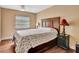 Bedroom with wooden floors, large bed, ceiling fan and window at 2315 Riverwood Pines Dr, Sarasota, FL 34231