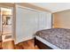 Bedroom with wooden floors, closets and en-suite bathroom with sink and mirror at 2315 Riverwood Pines Dr, Sarasota, FL 34231