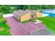 Low aerial showcasing the home's full front elevation, and surrounding lot at 2315 Riverwood Pines Dr, Sarasota, FL 34231
