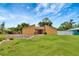 The exterior of the home features a well-manicured front lawn and landscaping at 2315 Riverwood Pines Dr, Sarasota, FL 34231