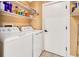 Laundry room featuring washer, dryer, shelving and door at 2315 Riverwood Pines Dr, Sarasota, FL 34231