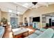 Bright living room featuring vaulted ceilings, skylights, ceiling fans and sleek wood flooring at 2315 Riverwood Pines Dr, Sarasota, FL 34231