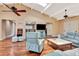 Bright living room boasts vaulted ceilings, ceiling fan, hardwood floors, and comfortable seating at 2315 Riverwood Pines Dr, Sarasota, FL 34231