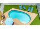 Aerial view of the backyard pool, and lounging area surrounded by turf at 2315 Riverwood Pines Dr, Sarasota, FL 34231
