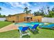 Backyard features a sparkling pool, patio area, lounge chairs and manicured lawn at 2315 Riverwood Pines Dr, Sarasota, FL 34231