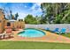 Backyard pool area with patio seating and well-maintained landscaping at 2315 Riverwood Pines Dr, Sarasota, FL 34231