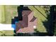 Overhead view of a well-maintained home with an expansive roof, fenced yard, and freshly paved driveway at 2405 Mistleto Ln, North Port, FL 34286
