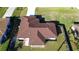 Aerial shot of a home with a neatly landscaped yard, fenced perimeter, and a durable roof at 2405 Mistleto Ln, North Port, FL 34286