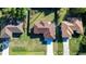 Bird's eye view showcasing a home with a large, fenced yard, surrounded by lush greenery and neighboring houses at 2405 Mistleto Ln, North Port, FL 34286