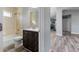 Bathroom featuring a tiled shower, neutral walls, and a dark wood vanity with white countertop at 2405 Mistleto Ln, North Port, FL 34286