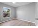 Bedroom featuring a window with a view, ceiling fan, and wood-look vinyl floors at 2405 Mistleto Ln, North Port, FL 34286
