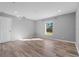 Serene bedroom with wood-look floors, neutral paint, recessed lighting, and a bright window at 2405 Mistleto Ln, North Port, FL 34286