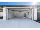 A clean and spacious garage featuring an epoxy floor, modern lighting, and ample space at 2405 Mistleto Ln, North Port, FL 34286