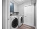 Laundry room featuring modern washer and dryer, a utility sink, a cabinet, and vinyl floors at 2405 Mistleto Ln, North Port, FL 34286
