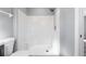 Bright white shower with tile surround, built-in seat, and neutral wall color at 2405 Mistleto Ln, North Port, FL 34286