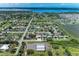 Scenic aerial view showcasing the neighborhood layout, nearby lake, and coastal features at 2406 15Th W St, Palmetto, FL 34221