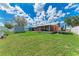 Expansive backyard featuring lush lawn, a shed, a screened-in lanai, and boat parking at 2406 15Th W St, Palmetto, FL 34221