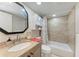 Well-lit bathroom featuring a granite vanity, tub with tiled walls, and stylish fixtures at 2406 15Th W St, Palmetto, FL 34221