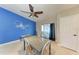 Dining area with modern lighting, seating for six, bright blue accent wall with a jellyfish graphic at 2406 15Th W St, Palmetto, FL 34221