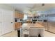 Well-lit kitchen with stainless steel appliances, wood cabinets, and center island with breakfast bar seating at 2406 15Th W St, Palmetto, FL 34221
