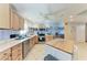 A kitchen features stainless steel appliances, wooden cabinetry, an island, and stylish wall decor at 2406 15Th W St, Palmetto, FL 34221