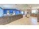 Spacious open-concept living area with a large sofa and views of the dining and kitchen areas at 2406 15Th W St, Palmetto, FL 34221