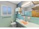 Bathroom features turquoise tile and a large mirror at 2850 Bon Air Ave, Sarasota, FL 34234